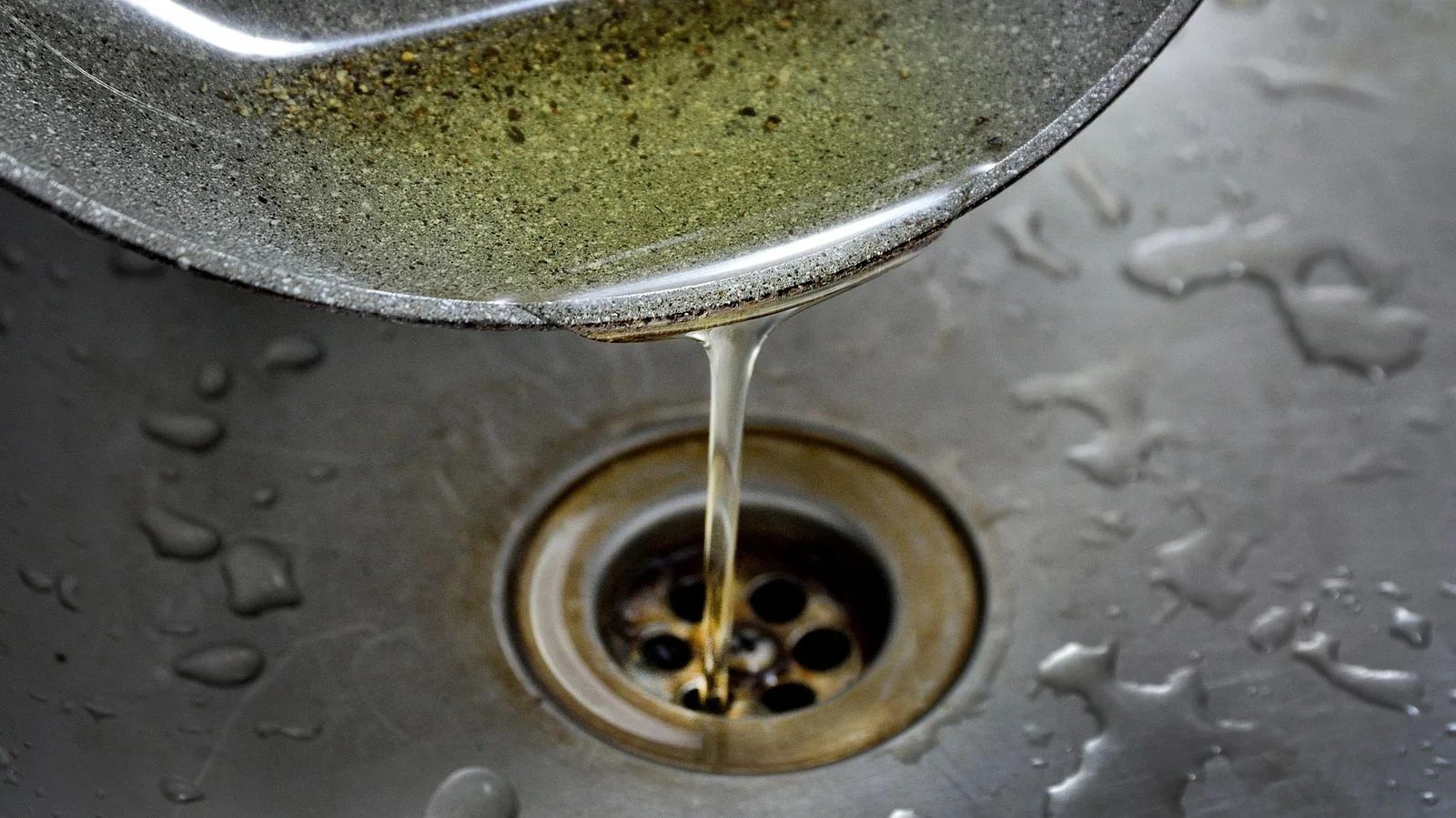 Improper disposal of cooking oils Cooking oil being poured down a sink drain